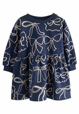 Robe bébé bleu marine à manches longues avec taille froncée, décorée d'un nœud crème et de dessins de rubans partout.