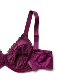 Mauve krūšturis ar mežģīņu apdari, caurspīdīgām sieta krūšu kausēm, regulējamām siksniņām un mīkstu apakšdaļu. Iezīmē gludu, noapaļotu formu un dekoratīvu apdari.