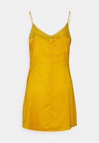 Robe jaune à bretelles spaghetti avec un col en V, un buste structuré et un détail de fermeture éclair au dos. Tissu lisse avec une silhouette ajustée.