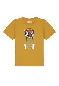 Gelbes Baumwoll-T-Shirt mit einem Tiger-Design, kombiniert mit einem grafischen Shirt und Hosenträgern. Das Design enthält gepunktete Muster auf dem Shirt.