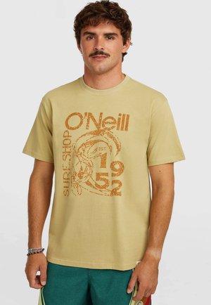 Beige cotton t-shirt featuring an orange graphic print with text "O'Neill Surf Shop EST 1952." Classic crew neck and short sleeves.