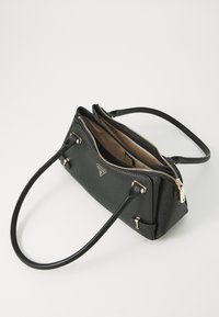 Black synthetic handbag with dual zippers, gold-toned hardware, a textured surface, adjustable straps, and beige interior lining with logo print.