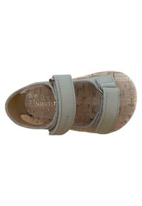 Sandalia gris claro con dos correas ajustables, plantilla de corcho y punta redondeada. Las superficies parecen suaves con un sutil detalle de costura y marca.