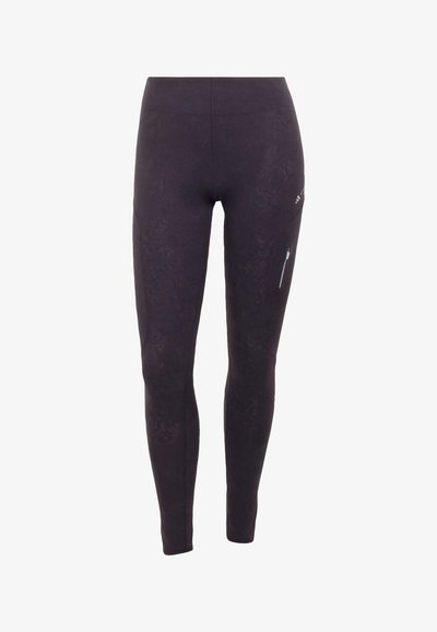 Schwarze, knöchellange Leggings mit hoher Taille und einer Reißverschlusstasche am rechten Oberschenkel.