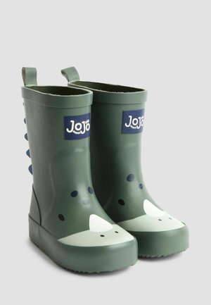 Grüne Gummiregenstiefel mit Dinosaurierdesign, ausgestattet mit einer strukturierten Oberfläche, runder Zehenpartie und kontrastierenden weißen und schwarzen Details.