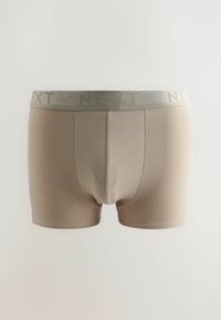 Boxer in cotone beige da uomo con una ampia fascia elastica in vita su cui è riportato il nome del marchio "NEXT" in una tonalità discreta.