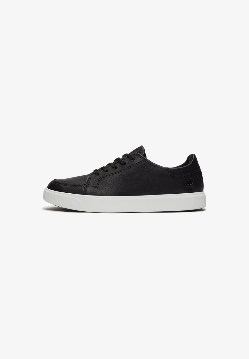 Black leather sneakers with a smooth texture, rounded toe, and white rubber sole. Features black laces and a logo on the heel.