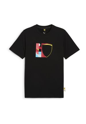 Sort bomulds T-shirt med et flerfarvet grafisk design med geometriske former og en gul kontur i form af et skjold. Korte ærmer og rund hals.