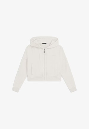 Hoodie coupé en crème, fabriqué en tissu doux. Il possède une fermeture éclair à l'avant, des poches kangourou et une capuche ajustable avec des manches côtelées.