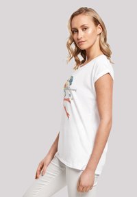 White short-sleeve t-shirt made of cotton, featuring a colorful graphic design of a character and lettering across the front.