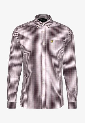 Herrenhemd mit langen Ärmeln und Knopfleiste, in lila-weißem Vichy-Karo-Muster und kleinem gelbem Vogel-Logo auf der Brusttasche.