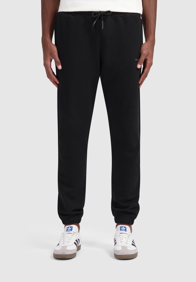 Zwarte sweatpants gemaakt van een katoenmix, met een elastische tailleband met een trekkoord, taps toelopende benen en omgeslagen onderkanten. Past goed bij witte sneakers.