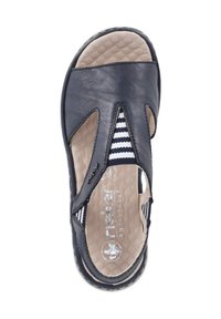 Leather sandal in navy with cut-out design, striped fabric accents, cushioned insole, and textured sole. Features a rounded shape.
