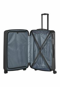 Valise rigide noire, ouverte pour révéler un intérieur bleu-gris avec un compartiment zippé et des sangles croisées pour maintenir les objets en place. Roues lisses et poignée.