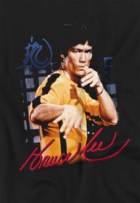 Black t-shirt featuring a prominent graphic of a man in a yellow outfit performing a martial arts pose, with red and blue text accents.