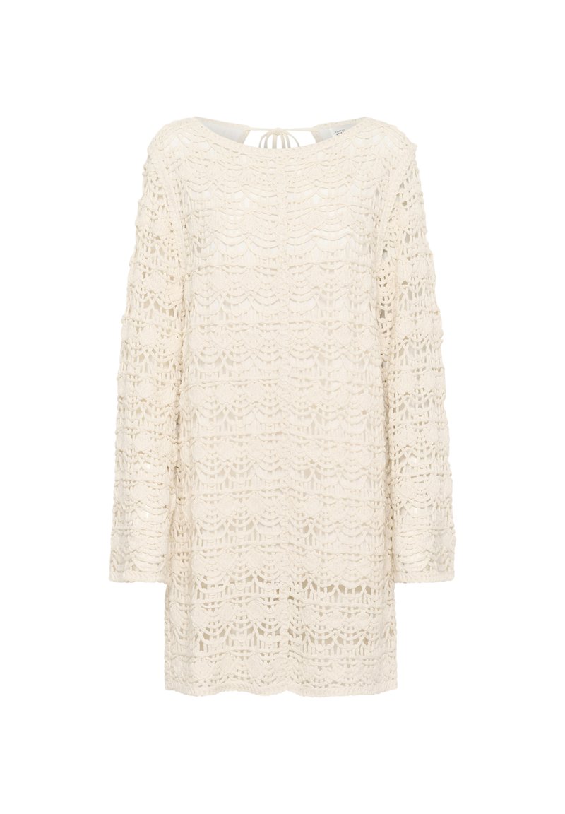 Spetstopp i off-white med långa ärmar, med en vågformad mönstring och en knytning i ryggen. Texturerad, öppen stickad design.
