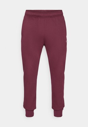Bordeauxfarbene Sweatpants aus weichem Stoff, mit einem elastischen Bund und gerippten Säumen. Enthält ein kleines Logo auf der linken Seite.