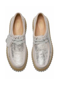 Silver textured sneakers made of a metallic material with a gray suede accent. Rubber sole with a patterned grip for traction.