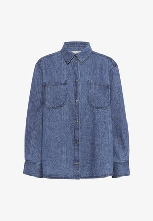 Tamsiai mėlynas džinsinis marškinis su kontrastinėmis baltomis siūlėmis. Yra dvi krūtinės kišenės ir mygtukų užsegimas priekyje. Ilgos rankovės su mygtukų rankogaliais.