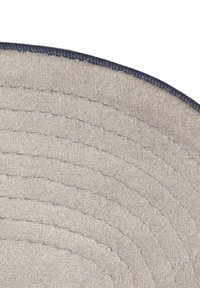 Close-up of a beige fabric hat brim with visible stitching and a dark blue edge trim against a white background.