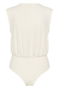Αμάνικο μπεζ κορμάκι με ελαστική μέση και ψηλές ανοίγματα στα πόδια, εμφανίζεται από πίσω σε απλό φόντο.