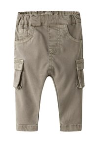 Beežid vabaaja püksid elastse vöökohaga, kahe küljetasku ja kahe väike taskuga, valmistatud tekstuurse kangaga, millel on õmmeldud detailid.