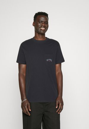 Navy blue cotton t-shirt featuring a pocket on the left chest with colorful "BILLABONG" logo, crew neckline, short sleeves, and a relaxed fit.