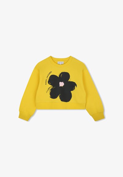 Geel cropped sweatshirt van katoen, met een groot zwart bloemenpatroon met een roze midden. Inclusief geribde boorden en halslijn.