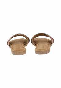 Pair of tan flat sandals with cushioned footbeds and single pink glittery straps across the top, shown from the heel side on a white background.