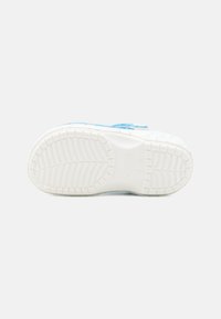 Blue slip-on shoe with a textured rubber sole, featuring a solid white base and floral design on the upper part. Smooth finish, practical design.