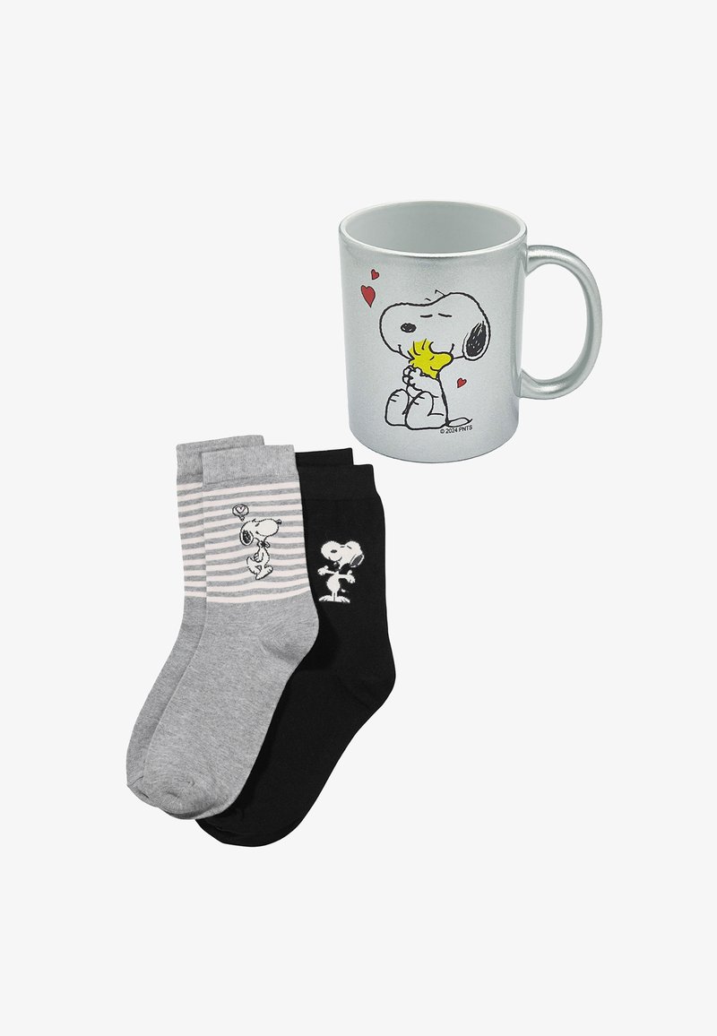 A silver mug featuring Snoopy artwork, accompanied by two pairs of socks: one black with Snoopy prints, one gray with stripes and a Snoopy design.