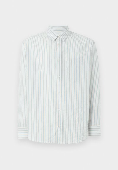 Gombos ing világoskék és fehér csíkos mintával. Gallérral, hosszú ujjakkal és bal oldalon egy zsebbel rendelkezik.
