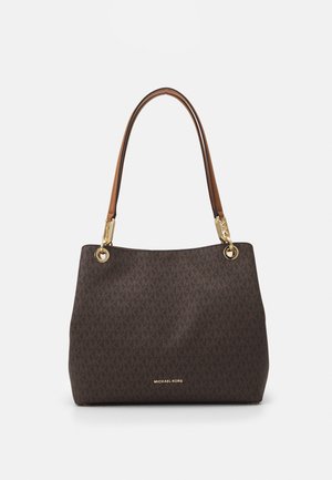 Brown monogram tote bag with leather handles, gold-tone hardware, and contrasting logo detail. Smooth texture with structured shape.