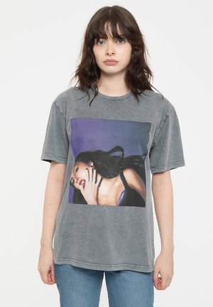 Gray cotton t-shirt featuring a large, colorful print of a woman with dark hair and a black top, set against a purple background.