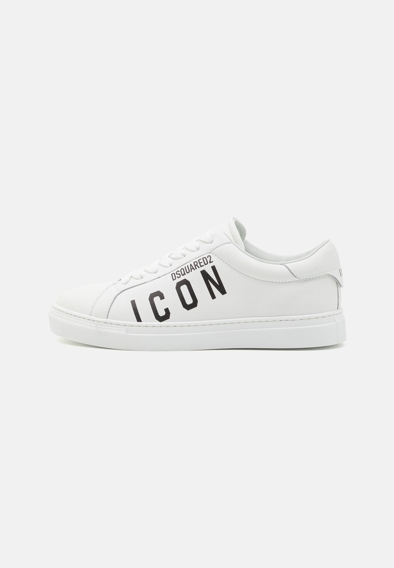 White leather sneakers with a flat sole, featuring black "ICON" text and brand logo. Smooth texture, rounded toe, and eyelet lacing system.