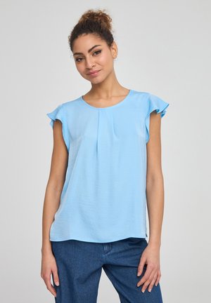 Blusa azzurro chiaro a maniche corte con spalle arruffate, scollo rotondo e pieghe sottili sul davanti. Realizzata in un tessuto morbido e testurizzato.