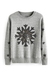 Sweat-shirt gris avec un grand motif de flocon de neige noir et métallique au centre. Comprend des accents d'étoiles noires sur les manches et des poignets côtelés.
