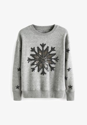 Sweat-shirt gris avec un grand motif de flocon de neige noir et métallique au centre. Comprend des accents d'étoiles noires sur les manches et des poignets côtelés.