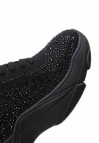 Black athletic shoe featuring a textured upper adorned with sparkling crystals, cushioned sole, and a rounded toe design.