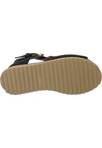 Black sandal with a smooth upper, adjustable buckle, and a ridged beige sole. Features a textured surface and a cushioned footbed.