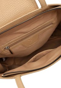 Sac fourre-tout en cuir texturé beige avec une fermeture éclair. L'intérieur dispose d'une poche zippée et d'une doublure en tissu lisse. Design épuré et minimaliste.