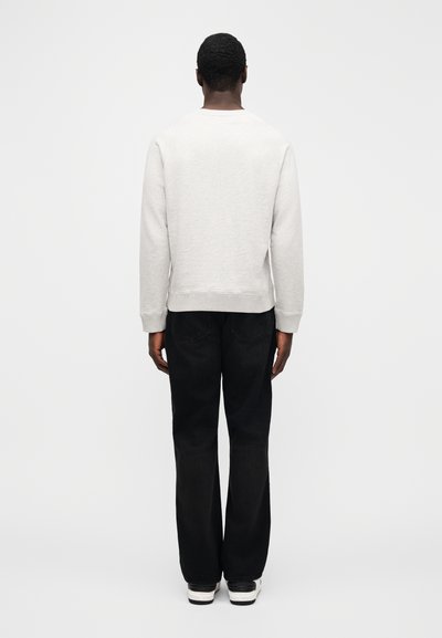 Gray sweater with a crew neckline and ribbed cuffs, worn with black jeans and white sneakers. Minimalistic design, simple and casual style.
