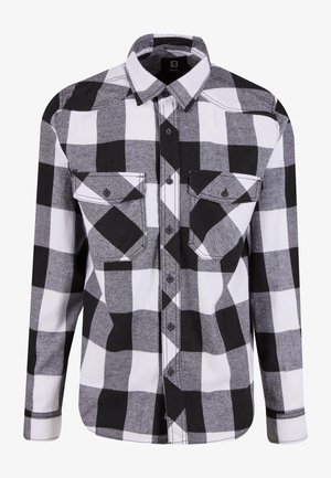 Camicia a maniche lunghe a quadri bianco e nero con chiusura a bottoni frontale, due tasche sul petto e dettaglio di cucitura a contrasto. Realizzata in tessuto morbido.