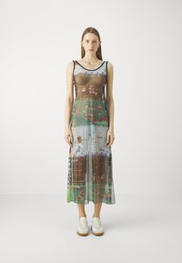 Sheer maxi dress featuring a colorful landscape print, with a scoop neckline and thin straps; an asymmetrical design with varied textures.