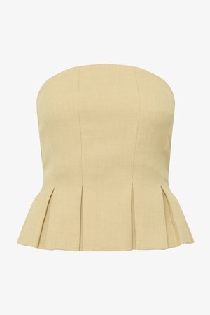 Μπεζ τοπ πεπλούμ χωρίς τιράντες με κάθετες ραφές και πιέτες στη μέση, που δημιουργούν μια φαρδιά σιλουέτα.