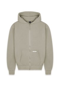 Hooded zip-up sweatshirt in a light beige color, featuring a front pocket, ribbed cuffs, and a logo tag on the pocket. Smooth texture.