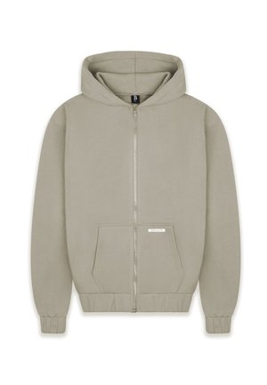 Hooded zip-up sweatshirt in a light beige color, featuring a front pocket, ribbed cuffs, and a logo tag on the pocket. Smooth texture.