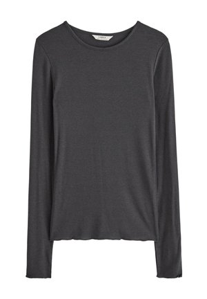 Pitkähihaista puseroa tummanharmaana, valmistettu pehmeästä ja joustavasta kankaasta. Ominaisuuksia ovat pyöreä pääntie sekä rento istuvuus, jossa on hieman kaareva helma.