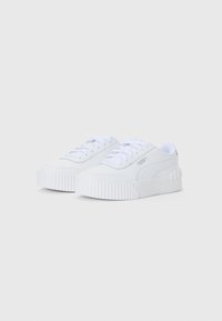 Pair of white Puma sneakers with thick ribbed soles and lace-up design, angled to show side and front details on plain background.