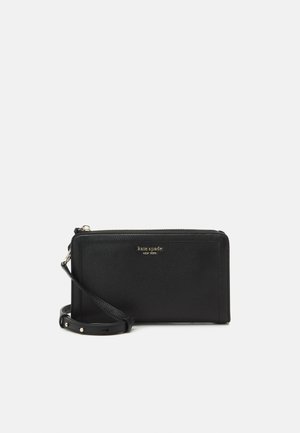 Black leather wallet with a textured surface, featuring a zip closure and a detachable wrist strap. Gold logo plaque on the front.